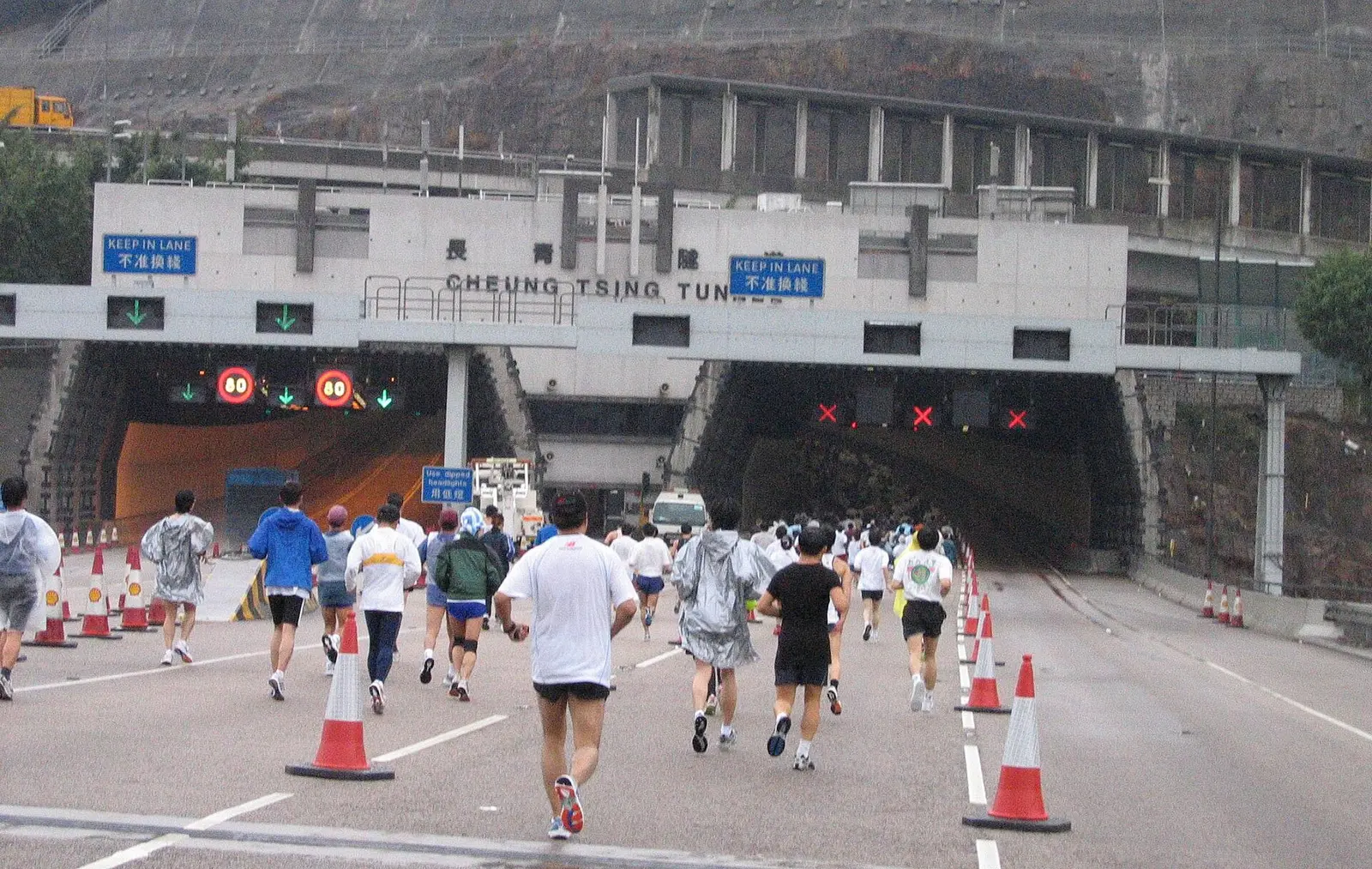 Runners in the Hong Kong Marathon on the road beside the Cheung Tsing Tunnel entrance