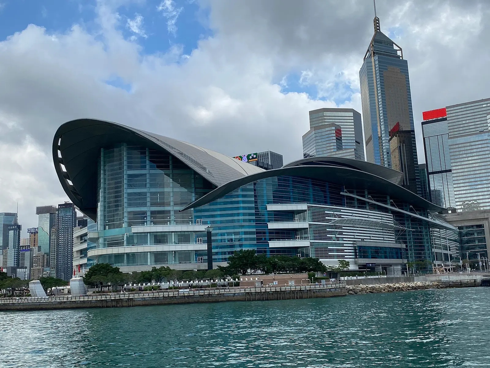 The curved roof of the Hong Kong Convention and Exhibition Centre beside the harbour in Wan Chai