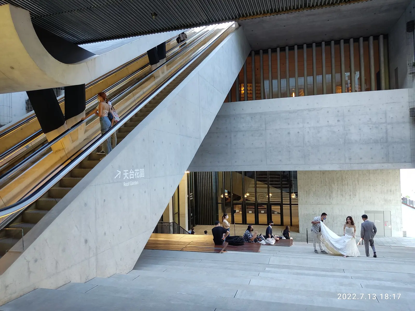 Escalators and concrete atrium inside the M+ museum in West Kowloon
