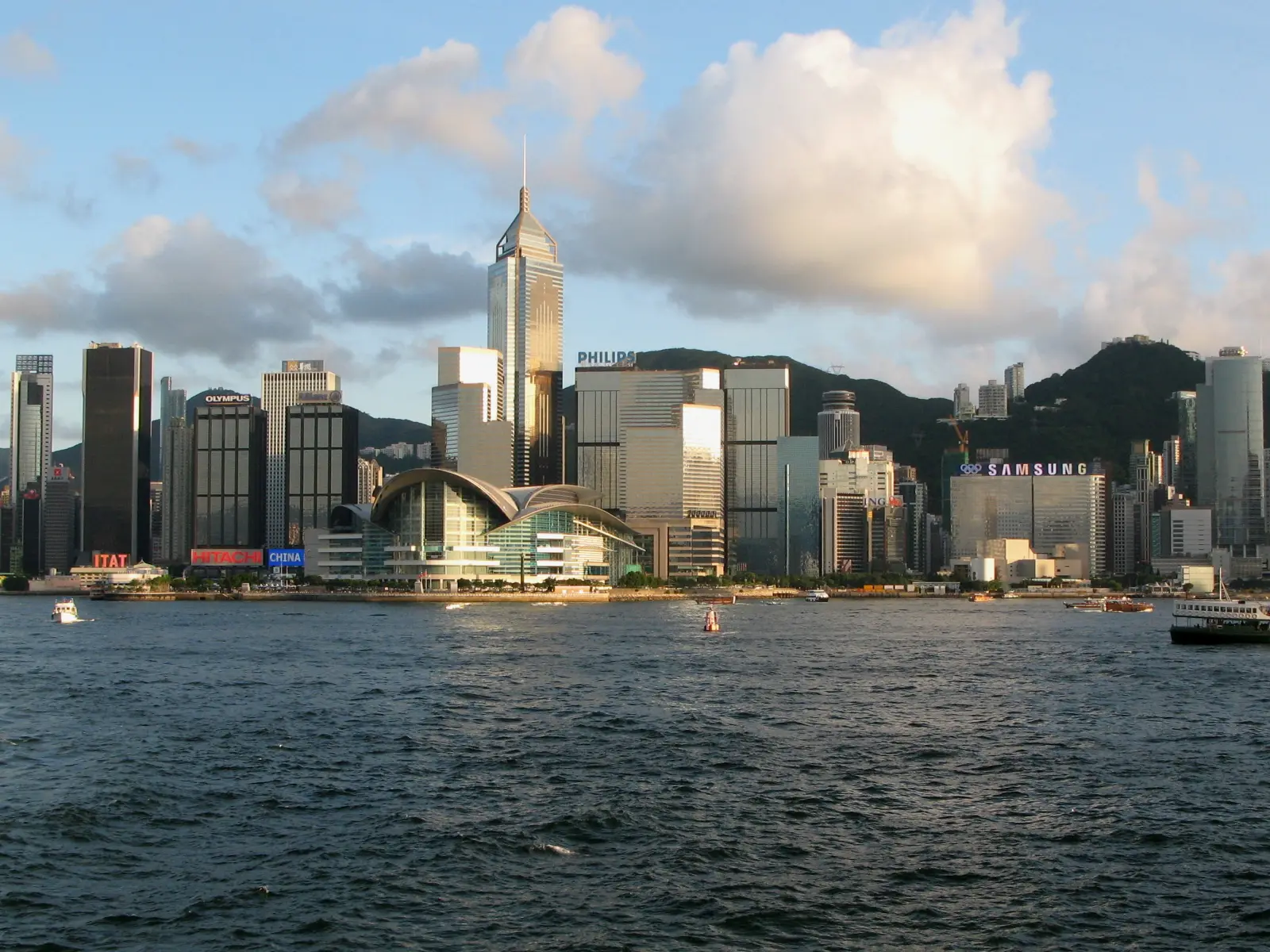 The Wan Chai waterfront with the convention centre and Central Plaza under a blue sky